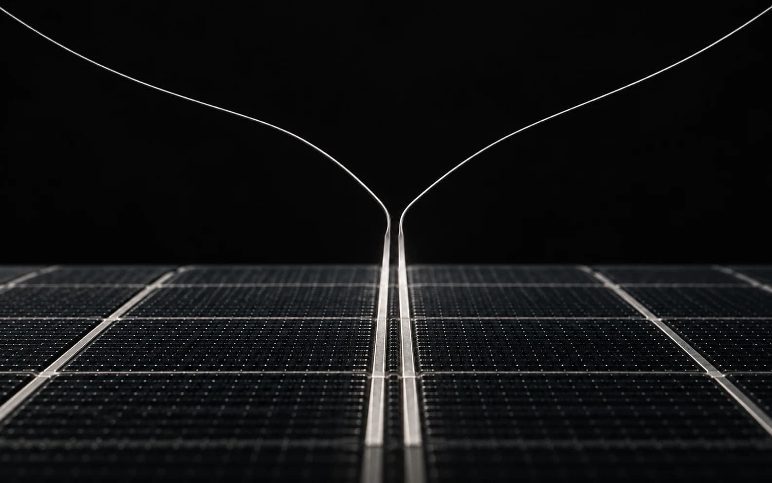 Two silver paths converge into the centered busbars of a dark photovoltaic surface